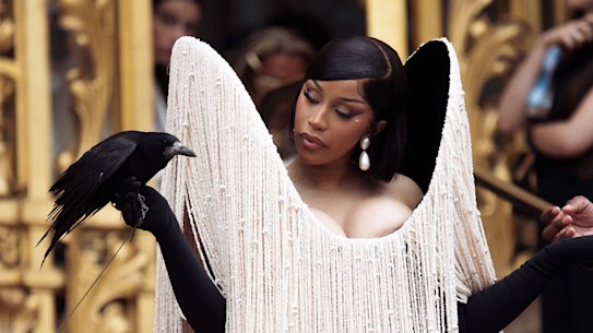 Cardi B accessorising with a crow at the Schiaparelli autumn/winter, 2025/2026 haute couture show in Paris.