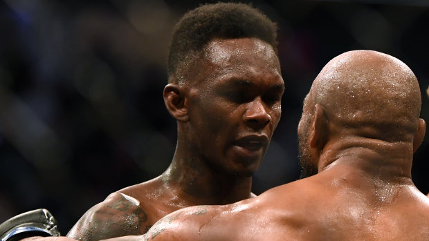 Champion effort: Israel Adesanya with Yoel Romero after the New Zealand fighter retained his UFC middleweight title.