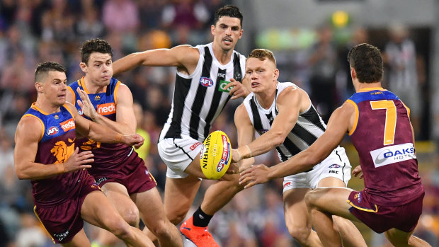 Handy: Adam Treloar (second from right) dominated in the midfield for the Magpies.