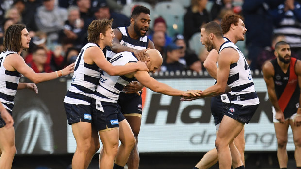 Masterful: Cats gather round to congratulate Gary Ablett after he slotted through a major against the Bombers.
