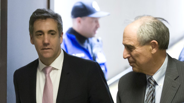 Michael Cohen (left) arrives to testify before a closed door hearing of the Senate Intelligence Committee.