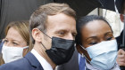 French President Emmanuel Macron poses for a selfie with residents during his visit to Les Mureaux, north-west of Paris.