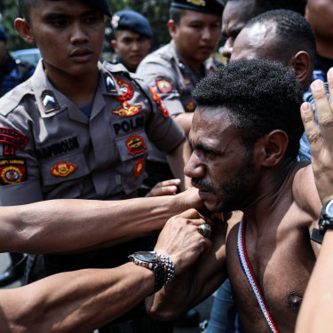 Police block Papuan protesters in Jakarta on August 22.