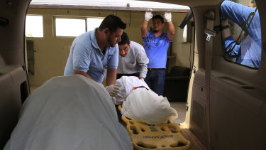 The bodies of El Salvadoran migrant Oscar Alberto Martinez Ramírez, 25, and his nearly two-year-old daughter Valeria, are placed into a funeral home van at the morgue in Matamoros, Tamaulipas state, Mexico.
