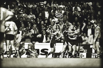 Agony and ecstasy: Ben Elias and Brad Fittler slump  to their knees as Queensland celebrate Mark Coyne's miracle try in 1994.