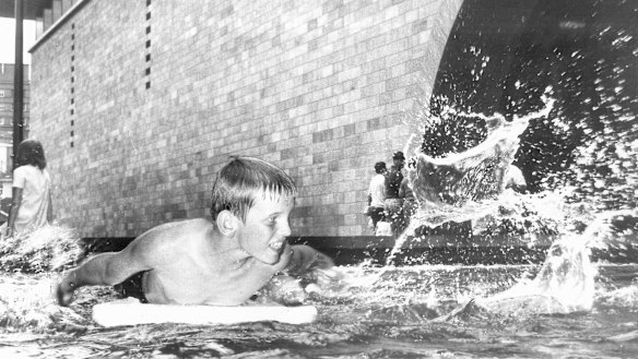 A boy splashes around in the NGV's exterior pool in 1968.