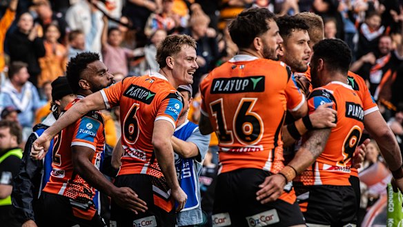 Lachie Galvin and the Tigers celebrate the win over the Sharks at Leichhardt.