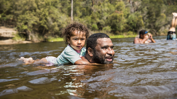 Local Villi Vai with his daughter Manu cool off at Simmo’s Beach, Macquarie Fields.
