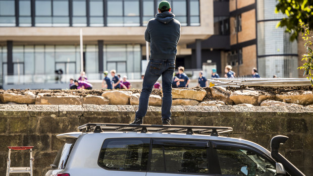 A spectator stands on the roof of a car to watch a schoolboy rugby match at St Joseph's College in Hunters Hill. 