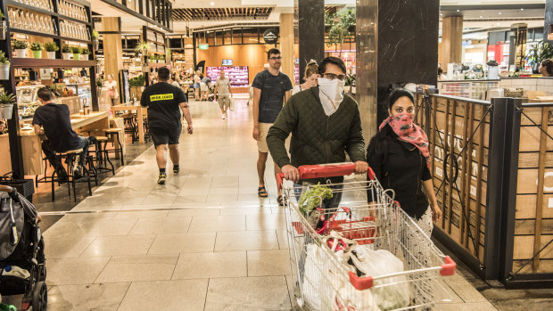 Shoppers at the Macquarie Centre take their own precautions to avoid the spread of coronavirus. 
