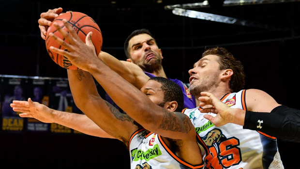 Both ends of the court: Top-scorer Kevin Lisch gets involved in the tough stuff against the Taipans.