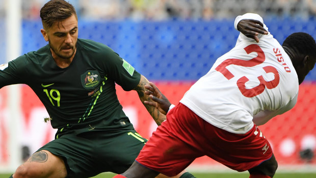 Revelation: Josh Risdon tackles the nimble-footed Pione Sisto of Denmark in another impressive showing in Russia.