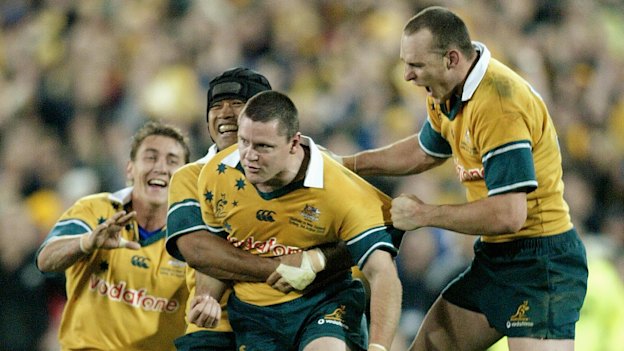 Matt Burke is mobbed by teammates after kicking the match-winning goal of the 2002 Bledisloe Cup series.