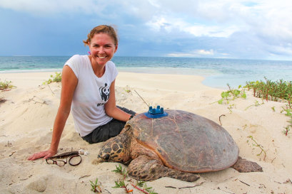 WWF turtle conservation expert Dr Christine Madden beside a satellite-tagged hawksbill turtle on Milman Island.