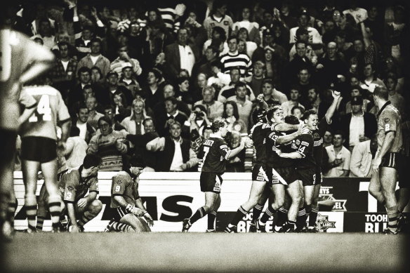 Agony and ecstasy: Ben Elias and Brad Fittler slump  to their knees as Queensland celebrate Mark Coyne's miracle try in 1994.