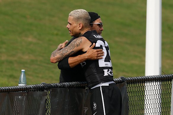Eddie Betts embraces Hill at training.