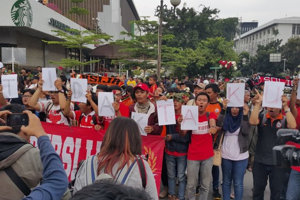 Jakarta soccer club supporters singing while holding letters saying “kami tidak takut” (We are not afraid” at an anti-terrorism rally outside Starbucks where a suicide bomb was detonated in 2016. 