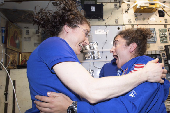 Christina Koch and Jessica Meir greet each other on the International Space Station.