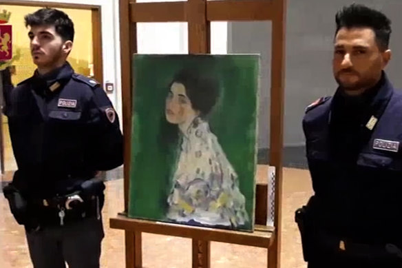 Italian police guard the Klimt after it was discovered in the gallery's wall.