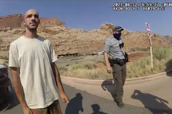 A police camera video still shows Brian Laundrie talking to a police officer on August 12.