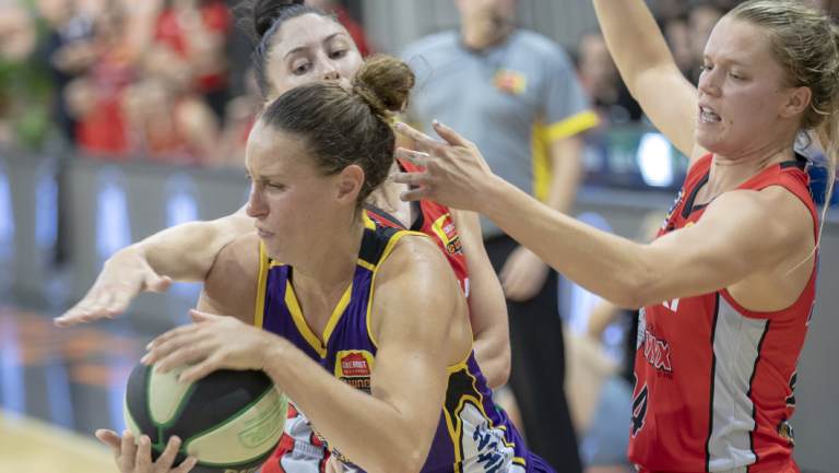 Swarming defence: Boomer Steph Talbot breaks free of a Perth Lynx trap. 