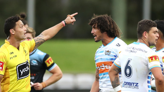 Kevin Proctor of the Titans is sent off by referee Henry Perenara for biting the forearm of Shaun Johnson of the Sharks during the round 14 NRL match between the Cronulla Sharks and the Gold Coast Titans at Netstrata Jubilee Stadium on August 15, 2020 in Sydney, Australia. 