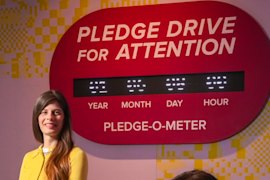 American artist Laura Allcorn (yellow top) with her work Pledge Drive For Attention.