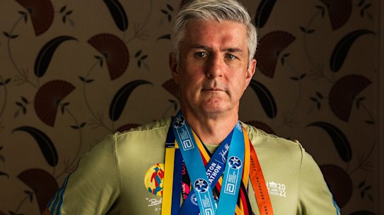 Joseph Moran wears the medals from every major marathon he has won.