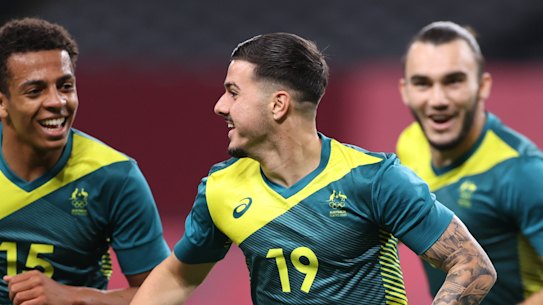 Marco Tilio (no.19) celebrates after scoring Australia’s second goal against Argentina on Thursday in Sapporo. Australia won 2-0.
