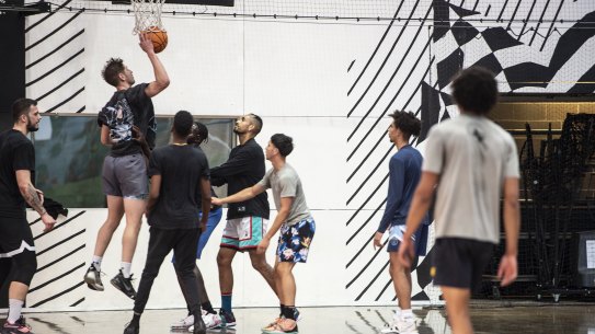 Nick Kyrgios in action with some of his new mates at King George V Recreation Centre last month.