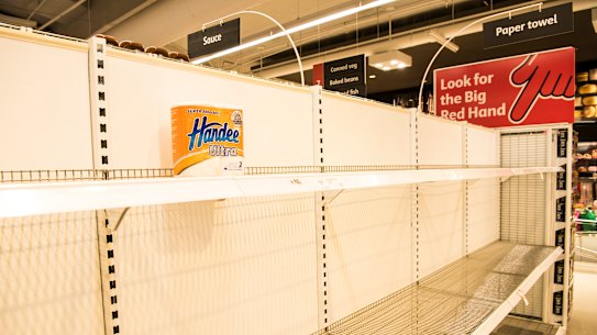 Empty toilet paper shelves at Coles.