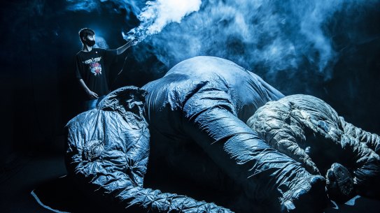 Tour guide Jimmy Hodgson, 14, holds a smoke machine over giant inflatable elephants. 