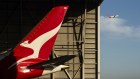 A Qantas aircraft at Sydney Airport. The company has said it will improve the customer experience, but is now charging more to change travel arrangements.