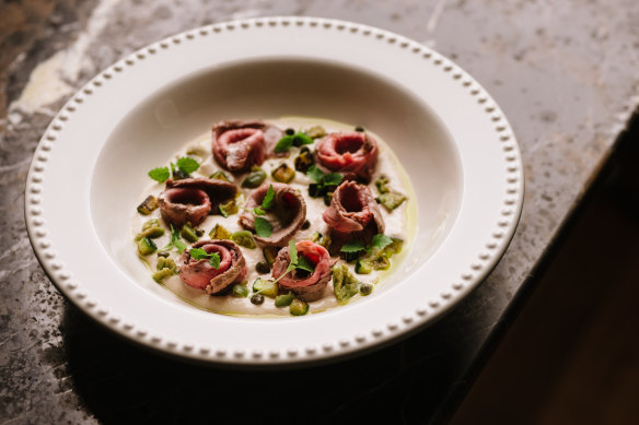 Vitello tonnato with olives, capers and grilled zucchini.