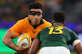 Hunter Paisami of the Wallabies runs the ball.
