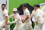 Australia's Mitchell Johnson, left, Michael Clarke, second from left, and David Warner, third from left, celebrate the wicket of England's Stuart Broad, on the fourth day of the series-opening Ashes cricket test between England and Australia at the Gabba in Brisbane, Australia, Sunday, Nov. 24, 2013. (AP Photo/Tertius Pickard)