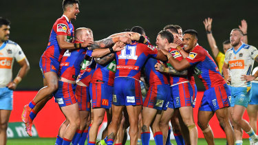Mitchell Pearce is swamped by teammates after his match-winning one-pointer.