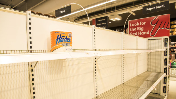 Empty toilet paper shelves at Coles.