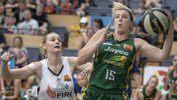 Safe hands: Rangers Sara Blicavs hauls in a rebound against Townsville’s Darcee Garbin. 