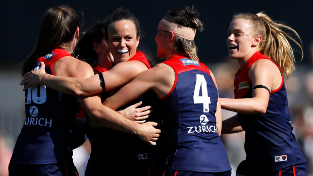 Daisy Pearce celebrates her telling goal with her Melbourne teammates.