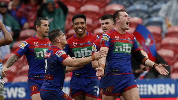 Lachlan Fitzgibbon celebrates a try in Newcastle's rout of the Titans.