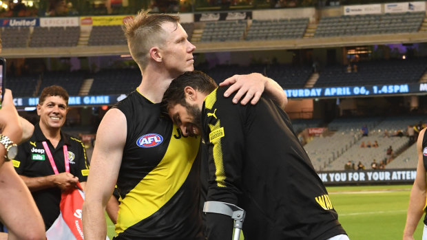 Richmond's Jack Riewoldt, left, comforts injured teammate Alex Rance.