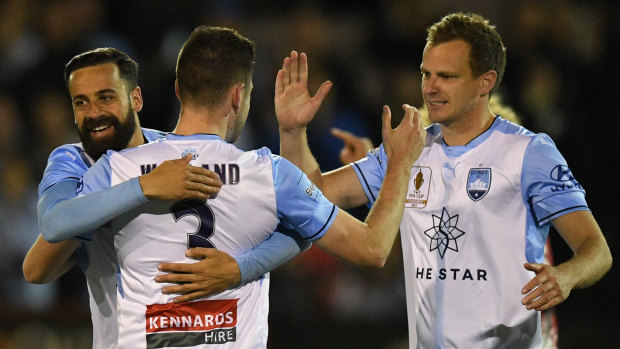 Nice work: Ben Warland is congratulated by Sydney FC veteran Alex Wilkinson after scoring his first career goal in the FFA Cup last year.