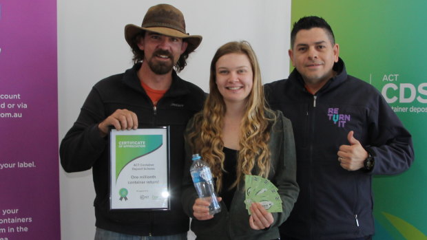 Jorge Rivera from Return.It (right), with Emily Scott and James Cottee, who deposited the one millionth container to Canberra's container deposit scheme