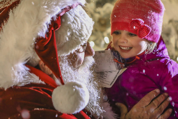 Hannah Kaleta, 4, of Florida, meets Santa Clause during the annual tree lighting in Beaver Creek, Colorado.