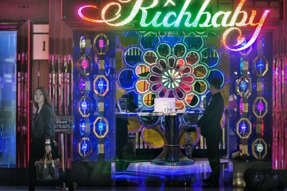 A young woman with a Louis Vuitton handback leaves 'Richbaby', a nightclub close to the hip Xintiandi shopping area. 