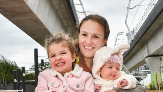 Dianne Liddell and her daughters Lillie Liddell (two) and Florence Liddell (4 months) under 'sky rail' in Carnegie.