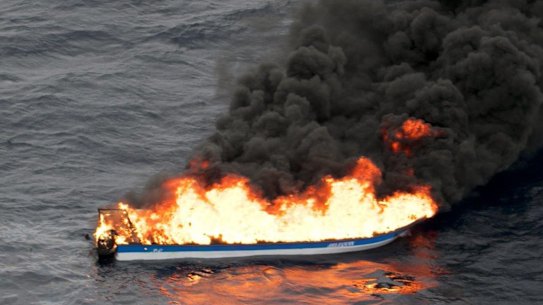 A speedboat off the South American coast on fire