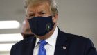 Donald Trump wears a mask after earlier playing down the seriousness of the virus infection.