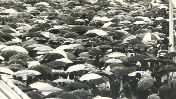 A sea of umbrellas as spectators watched the 1976 race in the pouring rain.